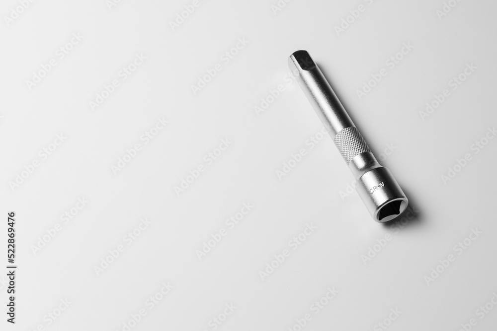 Fototapeta premium The socket wrench lies on a white table