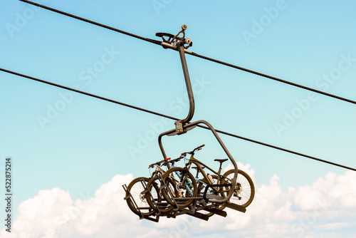 Slika na platnu Downhill Mountain Bikes on a Chairlift