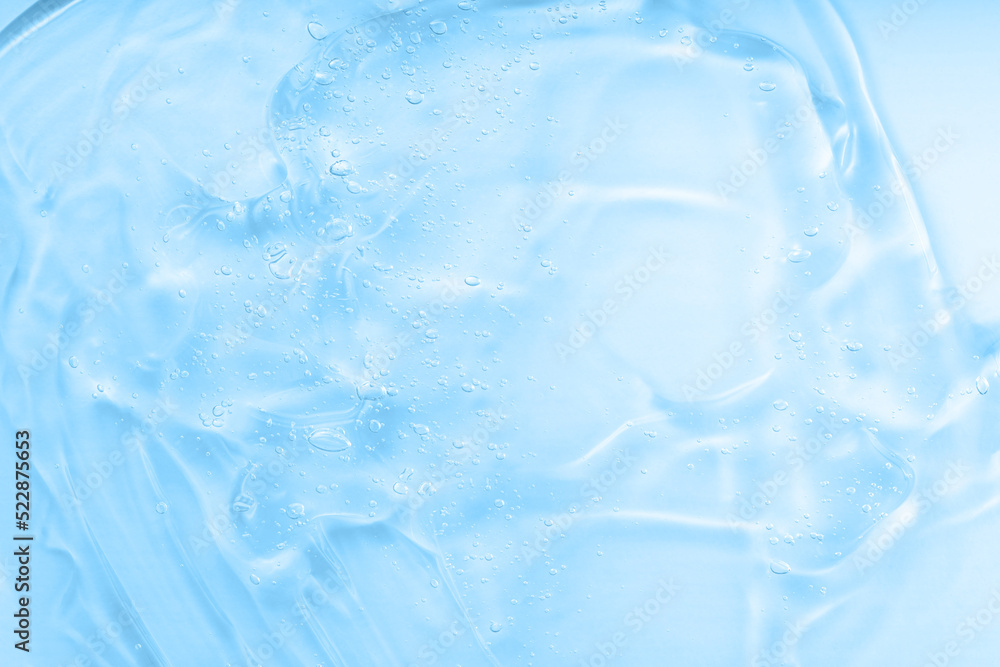 Cream gel blue transparent cosmetic sample with bubbles isolated on white background. Face serum texture. Clear skincare product smudge closeup. Hand sanitizer, hygiene liquid gel. Cream gel blue transparent cosmetic sample with bubbles isolated on white background. Face serum texture. Clear skincare product smudge closeup. Hand sanitizer, hygiene liquid gel.