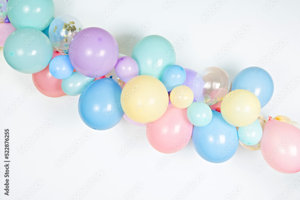 A close up image of a soft pastel balloon garland against a white background A close up image of a soft pastel balloon garland against a white background