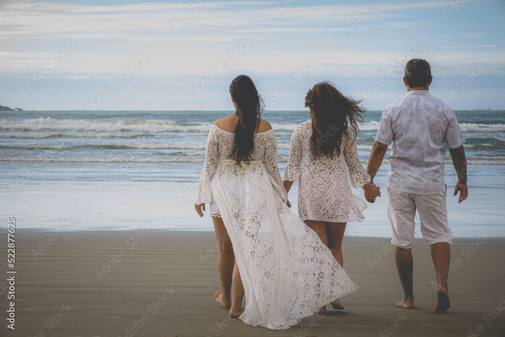 complete family on the beach, father, mother, daughter, mother pregnant with a baby. complete family on the beach, father, mother, daughter, mother pregnant with a baby.