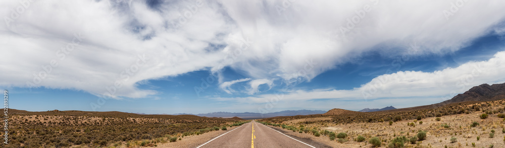 Panoramic View of Cloudy Cloudscape over the Scenic Road in the desert of American Nature Landscape. Nevada, United States of America. Nature Background Panorama Panoramic View of Cloudy Cloudscape over the Scenic Road in the desert of American Nature Landscape. Nevada, United States of America. Nature Background Panorama
