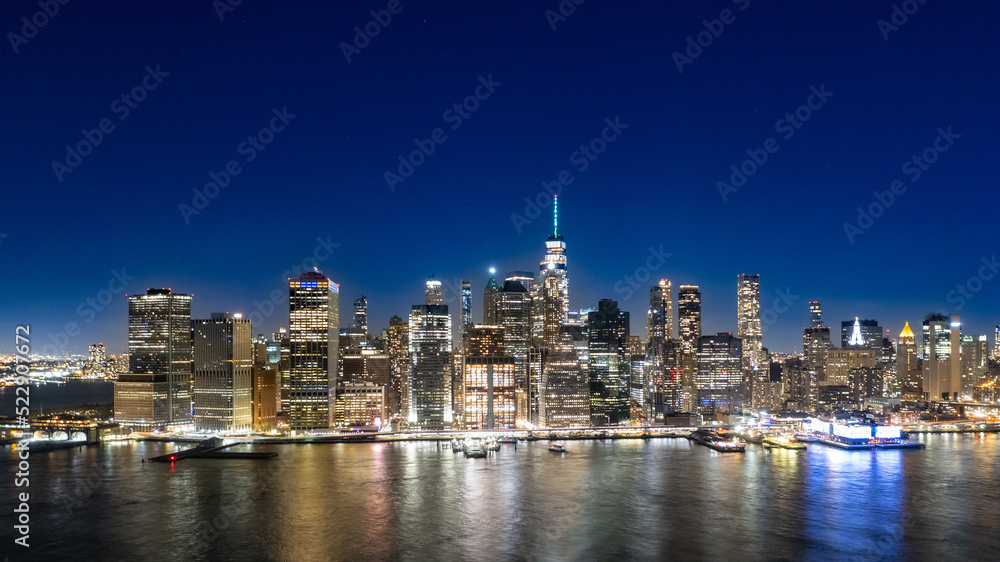 Wide angle view of Manhattan at night from Brooklyn Bridge Park 