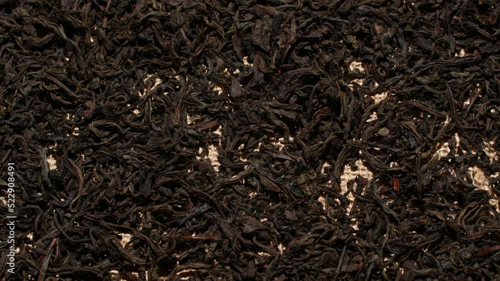 Close-up herbal black or green tea leaves texture on jute sack, food background Close-up herbal black or green tea leaves texture on jute sack, food background