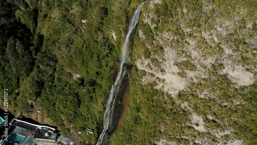 Cascada de la Virgen Flowing Down On Lush Cliff In Baños de Agua Santa, Ecuador - drone shot