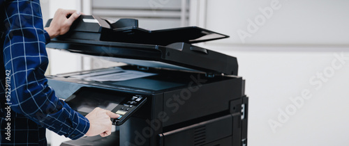 Copier printer, Close up hand office man press copy button on panel to using the copier or photocopier machine for scanning document printing a sheet paper.