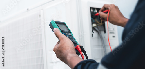 Wallpaper Mural Air conditioner technicians use a multimeter to check electricity and Part of the preparation to install a new air conditioner. Torontodigital.ca