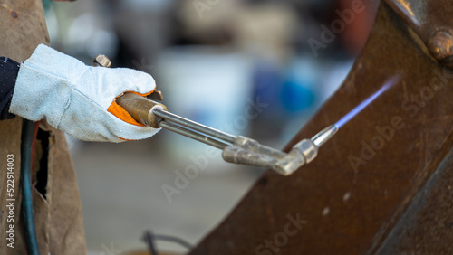 фотографія Industrial worker metal cutting with acetylene torch at factory welding steel structure, Welder is welding metalwork manufacturing construction maintenance service