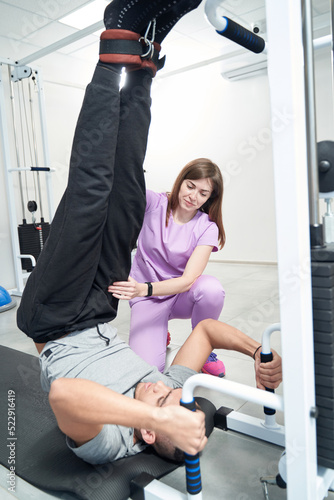 Man receiving physiotherapy rehabilitation treatment in clinic photo