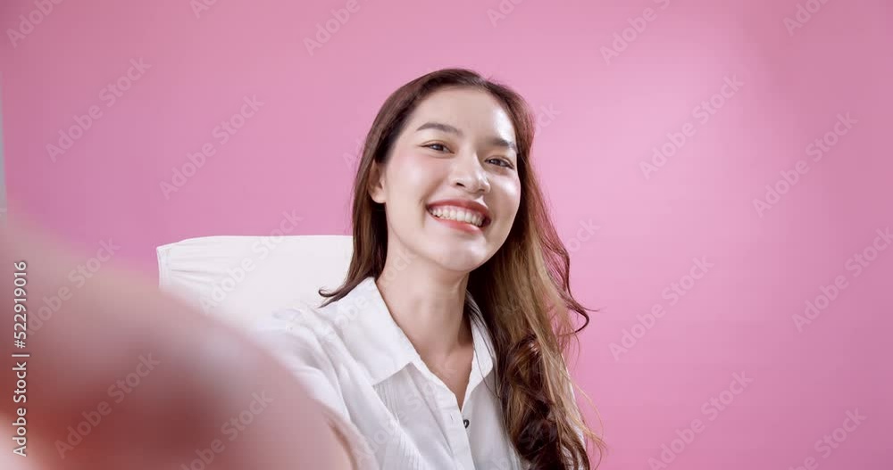 Young Asian woman greeting friends via video call Young Asian woman greeting friends via video call