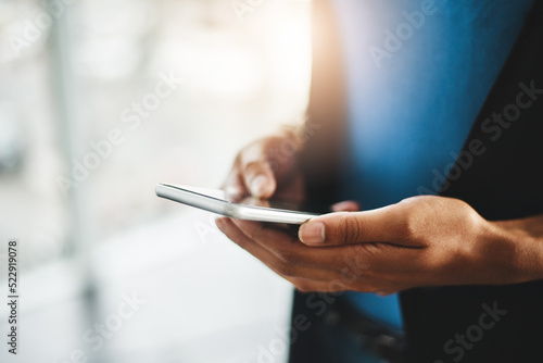 Fotografija businesswoman with a phone reading emails, text messages or checking news online on social media app