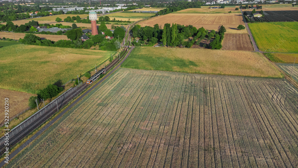tram passing between farming  fields at Edingen-Neckarhausen, Germany 