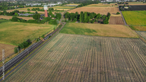 tram passing between farming fields at Edingen-Neckarhausen, Germany 