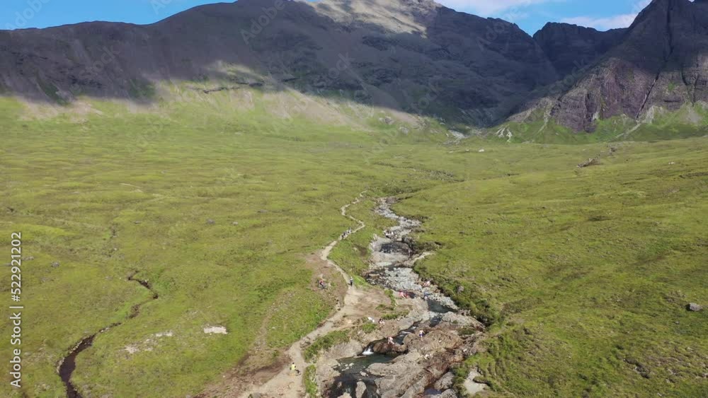 Magnificent drone shot of the Fairy Pools on Isle of Skye, Scotland. The shot starts low at the pools and raises up high, showing the expanse. Magnificent drone shot of the Fairy Pools on Isle of Skye, Scotland. The shot starts low at the pools and raises up high, showing the expanse.
