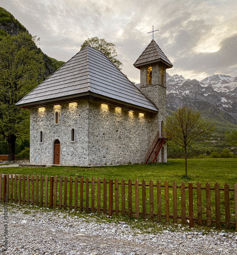 Fototapeta premium Theth, Albania, May 12, 2022 - small stone church in the afternoon