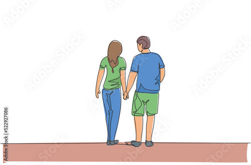 One continuous line drawing of young couple wife and husband walking and holding hand together, back view. Happy family parenting concept. Dynamic single line draw design vector illustration