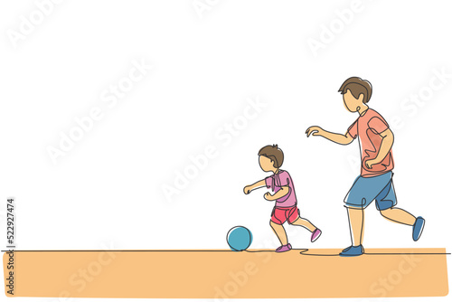 One single line drawing young dad running and playing football soccer with his son in public field park vector graphic illustration. Happy family parenting concept. Modern continuous line draw design