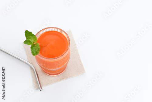 A glass of fresh carrot juice, very good for health. Served in glass on white background
