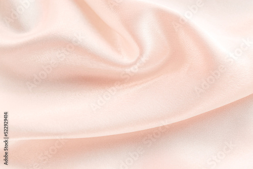 folds of beige silk fabric texture background