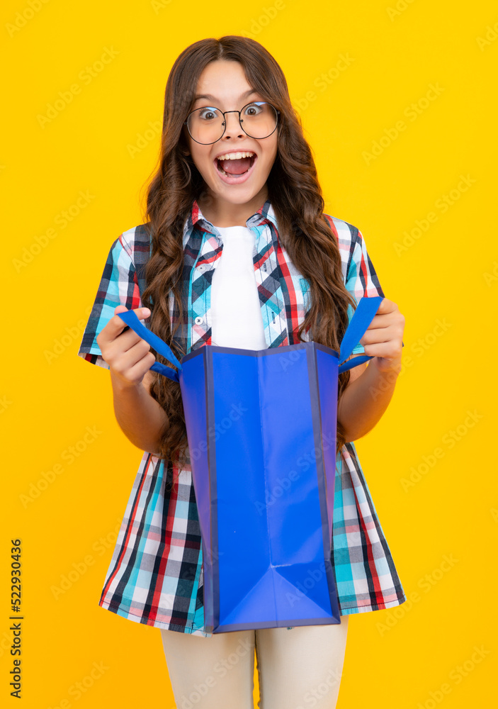 Amazed teen girl. Teenager hold shopping bag enjoying sale. Child girl is ready to go shopping. Excited expression, cheerful and glad. Amazed teen girl. Teenager hold shopping bag enjoying sale. Child girl is ready to go shopping. Excited expression, cheerful and glad.