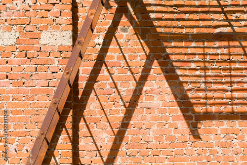 Fire stair shadow on the red brick wall.