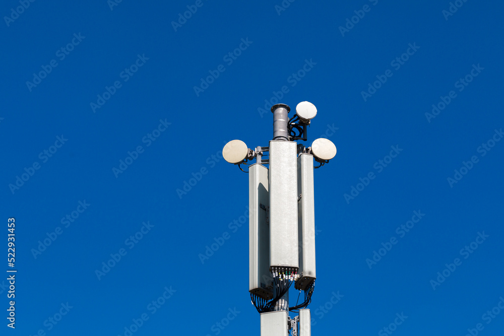 Communication antennas on a pole against the blue sky. Communication antennas on a pole against the blue sky.