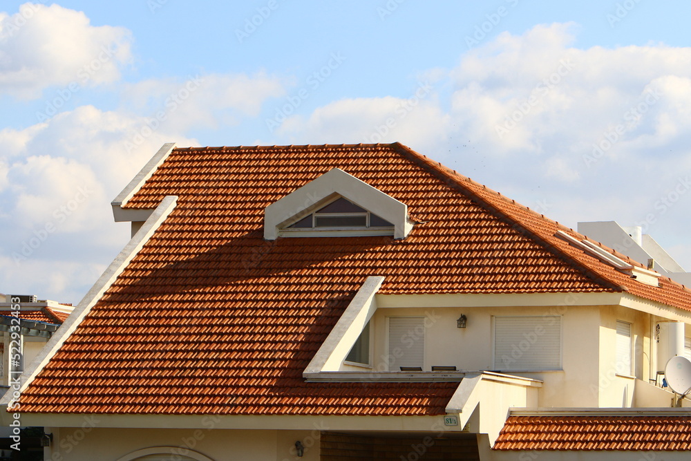 Red tiled roof on a residential building. Red tiled roof on a residential building.