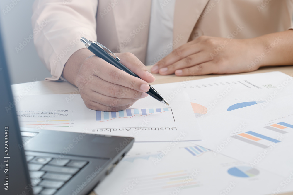 Business woman working for budget or report graph document paper on desk Business woman working for budget or report graph document paper on desk