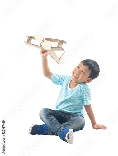 Принти на полотні kid dreams as pilot sitting and holding airplane paper isolated on white backgro