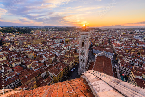 Slika na platnu The bell tower Giotto's Campanile with the rooftop of Santa Maria del Fiore Duomo in Florence during beautiful sunset