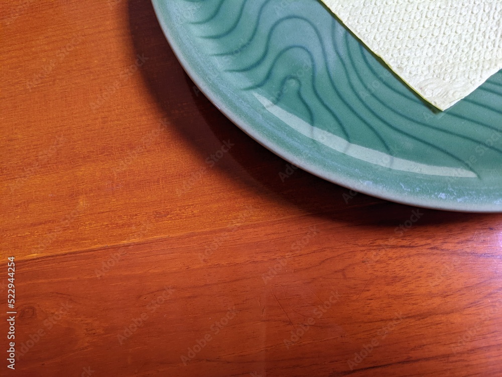 Close up of blue plate over the wooden table on the restaurant. The photo perfect for food promotion for, pamphlet of restaurant and drink advertising. Close up of blue plate over the wooden table on the restaurant. The photo perfect for food promotion for, pamphlet of restaurant and drink advertising.