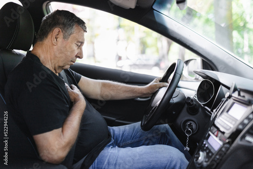 Senior behind the steering wheel with chest pain