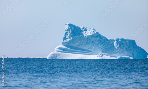 Poseidon, god of the sea - Melting icebergs by the coast of Greenland, on a beautiful summer day - Melting of a iceberg and pouring water into the sea - Greenland