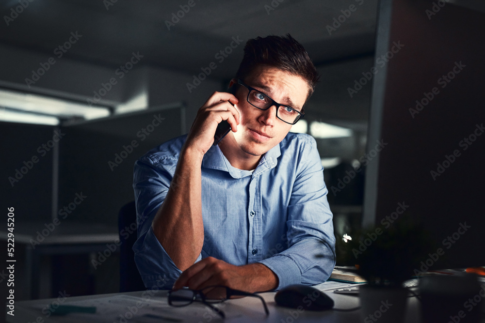 Stressed, overworked and worried while talking on phone to solve problem while working late night at the office. Serious and exhausted man calling IT about computer issue trying to reach deadline Stressed, overworked and worried while talking on phone to solve problem while working late night at the office. Serious and exhausted man calling IT about computer issue trying to reach deadline