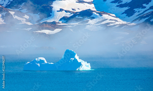 Poseidon, god of the sea - Melting icebergs by the coast of Greenland, on a beautiful summer day - Melting of a iceberg and pouring water into the sea - Greenland