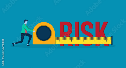 Businessman measure the word risk with measuring tape.