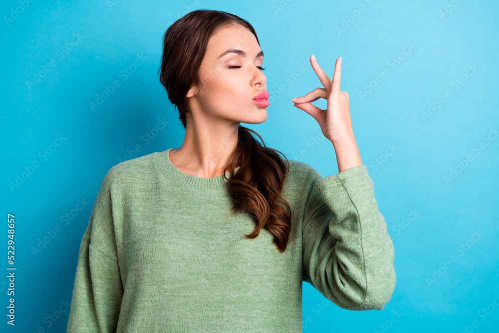 Photo of adorable satisfied person closed eyes arm fingers show gourmet gesture isolated on blue color background Photo of adorable satisfied person closed eyes arm fingers show gourmet gesture isolated on blue color background