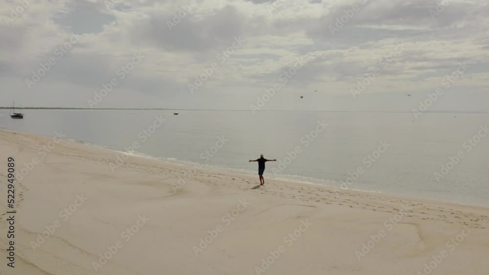 man on the beach with outstretched arms man on the beach with outstretched arms