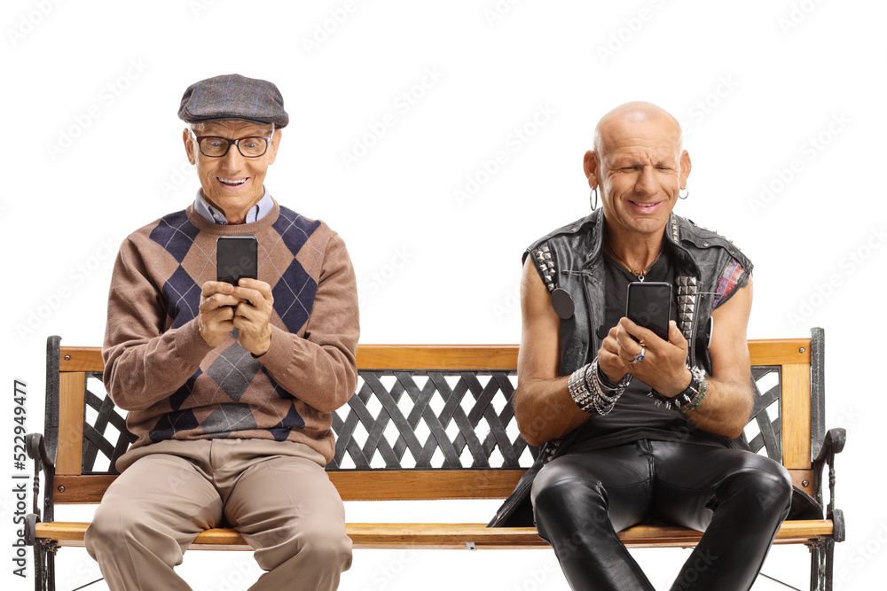 Elderly man and a punk using mobile phones and sitting on a bench Elderly man and a punk using mobile phones and sitting on a bench