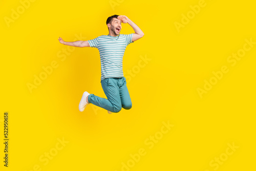 Full length photo of young crazy guy have vacation finally want go travel another country isolated on yellow color background