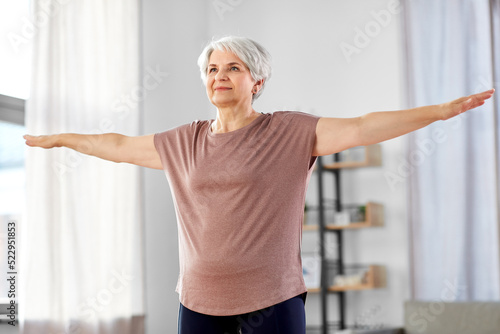 sport, fitness and healthy lifestyle concept - smiling senior woman exercising at home