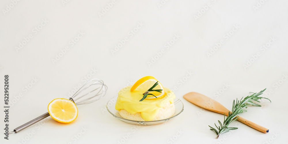 A round minimal sweet, sour and tasty Lemon chiffon or sponge cake. Decorated with rosemarry, whisk, paddle and lemon slice in a white background. Use for homemade minmal cafe style. Wide screen. A round minimal sweet, sour and tasty Lemon chiffon or sponge cake. Decorated with rosemarry, whisk, paddle and lemon slice in a white background. Use for homemade minmal cafe style. Wide screen.