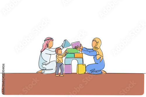 Single continuous line drawing of young Arabian couple playing brick foam puzzle house with their son. Islamic muslim family care, parenthood concept. Trendy one line draw design vector illustration
