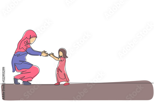 One continuous line drawing of young Islamic toddler daughter learn to walk while mom ready to catch. Happy Arabian muslim parenting family concept. Dynamic single line draw design vector illustration