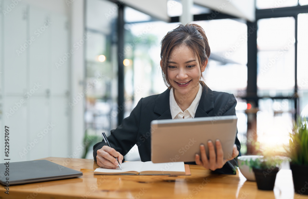 businesswoman using digital tablet and pen to take notes at office. businesswoman using digital tablet and pen to take notes at office.