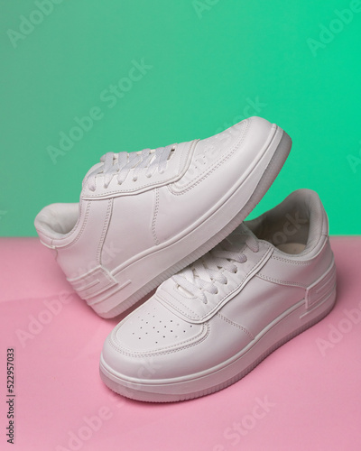 Wallpaper Mural Promotional photo of pair of new white women's or teen sneakers on colored background. Torontodigital.ca