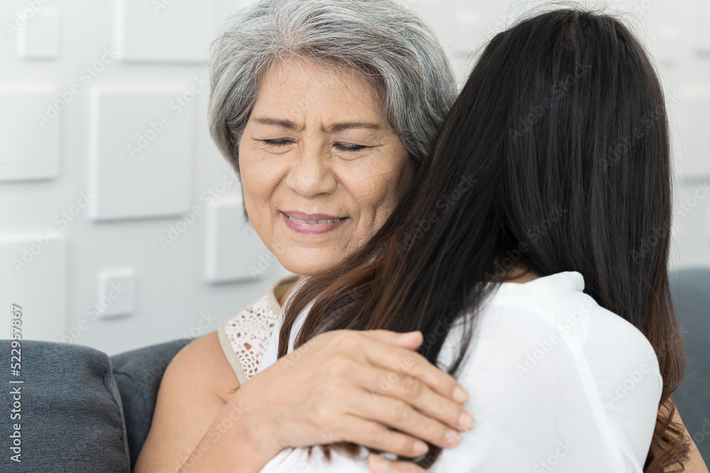 Elderly mum hugging grownup daughter at home. Close up happy older mature mother embracing young grownup daughter with kindly. Young woman carefully takes care of elder woman Elderly mum hugging grownup daughter at home. Close up happy older mature mother embracing young grownup daughter with kindly. Young woman carefully takes care of elder woman