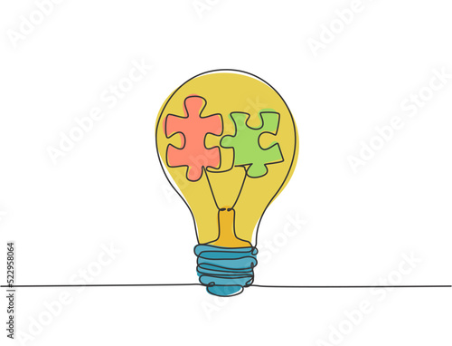 One single line drawing of lightbulb with puzzle pieces inside for creative team company logo identity. Power teamwork icon concept. Trendy continuous line draw design vector illustration