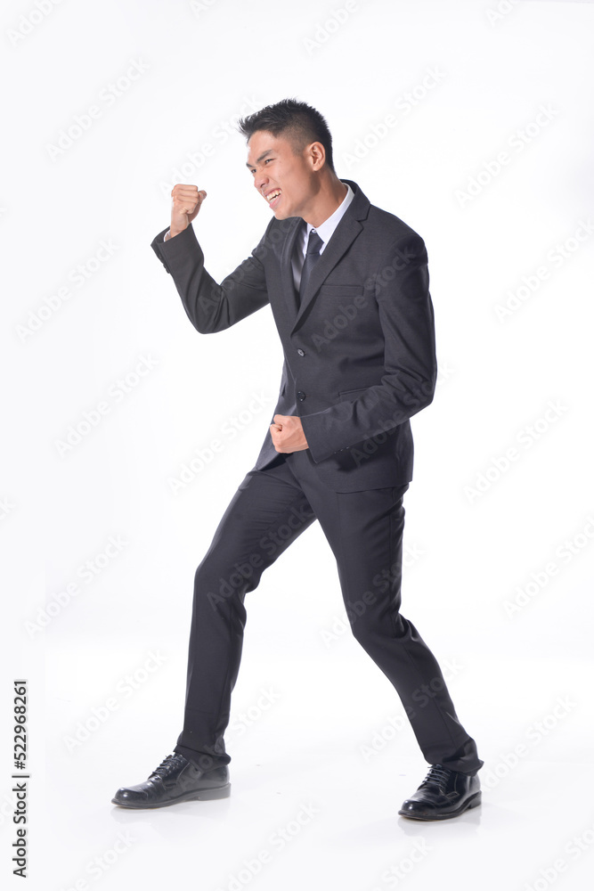 Handsome young business man
wear formal suit with black tie, raise her hand up doing winner gesture clenching fist and shouting yes
,Businessman portrait Isolated on white background
Handsome young business man
wear formal suit with black tie, raise her hand up doing winner gesture clenching fist and shouting yes
,Businessman portrait Isolated on white background