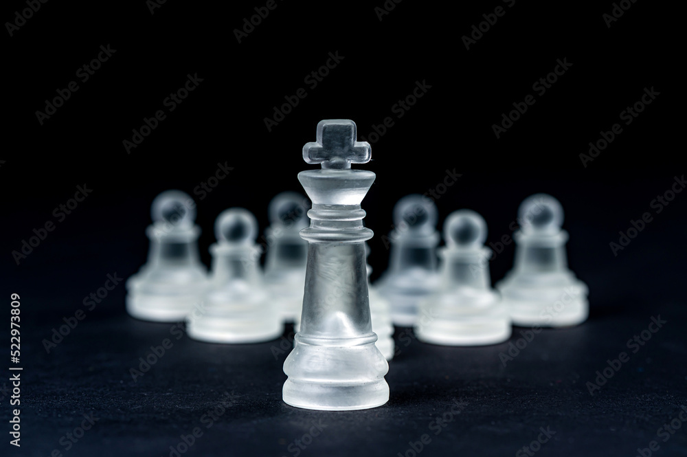 transparent glass chess on black background, selective focus on king piece, close up transparent glass chess on black background, selective focus on king piece, close up